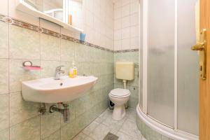 a bathroom with a sink and a toilet at House Ante in Grohote