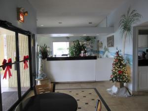 a kitchen with a christmas tree in a room at Dunes Inn & Suites - Tybee Island in Tybee Island