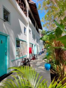 a courtyard of a building with chairs and plants at Gili Beach Bum Hostel in Gili Trawangan