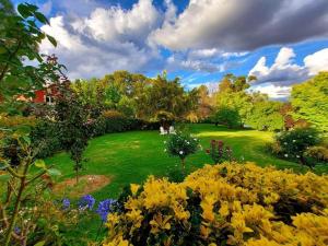 a garden with flowers in the middle of a field at Hawk's Nest Bed & Breakfast in Bathurst