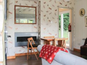 a living room with a couch and a mirror at The Garden House - Uk10987 in Llandogo