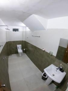 a bathroom with a sink and a toilet at Pinnawala Elephant Front View Hotel in Rambukkana