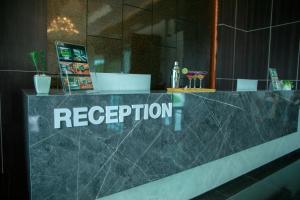 a reception counter with the word reception on it at Pim Pool Villa Nan in Nan