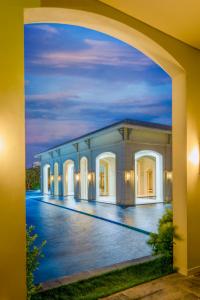an archway view of a building at night at FLC Luxury Resort Samson in Sầm Sơn