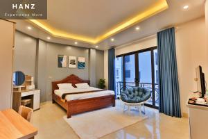 a bedroom with a bed and a balcony at HANZ Light House Hotel & Apartment in Hanoi