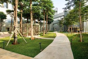 un parc avec des arbres et un trottoir devant un bâtiment dans l'établissement Comfy 2 bedroom TA, à Jakarta