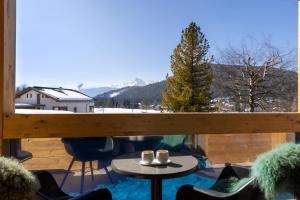 a balcony with a table and two mugs on it at Appartementhaus Anka in Seefeld in Tirol