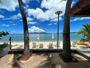 a view of the beach from a resort with chairs at The Shore Samui in Bang Rak Beach