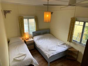 two beds in a room with two windows at 35 Flinders Ave in Dunwich