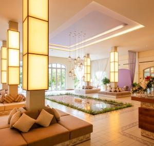 a lobby with a pond in the middle of a room at FLC Luxury Resort Samson in Sầm Sơn