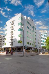 a large white building on a city street at Hotel Portobahia Santa Marta Rodadero in Santa Marta