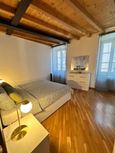 a bedroom with a bed and a table with a lamp at Stella / Bergamo center in Bergamo