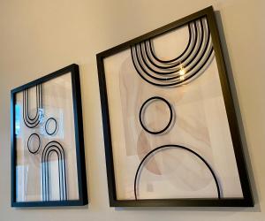 two framed pictures hanging on a wall at Apartament Odrzanka in Gryfino