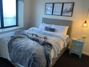 a bed with a blanket on it in a bedroom at Arlberg 314 in Mount Buller