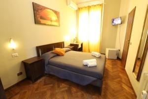 Uma cama ou camas num quarto em Carlo Goldoni Hotel