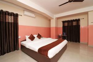 a bedroom with a large bed in a room at Prabha Palace Lodge in Kamakhya