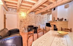 sala de estar con mesa, sillas y chimenea en Amazing Home In Goudargues With Kitchen, en Goudargues