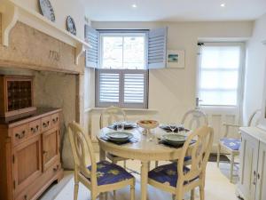 a kitchen with a table and chairs in a kitchen at Chareside Cottage in Corbridge