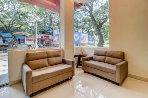 a waiting room with two chairs and a window at Itsy By Treebo - NRM Residency in Mysore