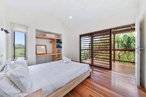 a bedroom with a large bed and a large window at Laguna in Point Lookout