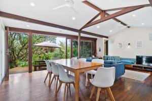 a dining room and living room with a wooden table and chairs at Laguna in Point Lookout