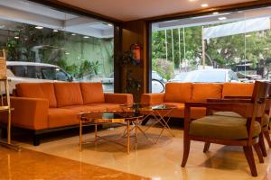 a living room with a couch and a table at 3 BY OYO Nami Residency Ahmedabad in Ahmedabad