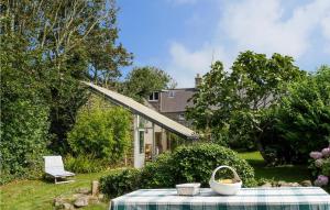 a picnic table in the yard of a house at 3 Bedroom Nice Home In St Germain Des Vaux in Auderville