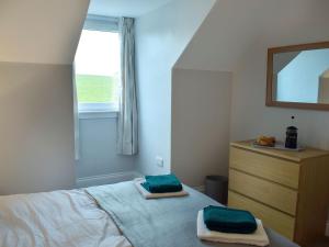 a bedroom with a bed with two towels on it at Brick Cottage 1-uk13674 in Palnure