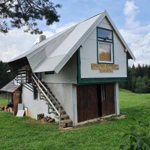 a building with a sign on the side of it at Planinska koliba Ajdanovici Jelovac Nisicka visoravan in Olovo