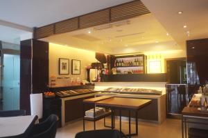 a kitchen with a stove and a table in it at Aqua Bella Hotel in Taipei