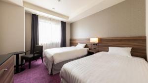 JR-East Hotel Mets Mito客房内的一张或多张床位