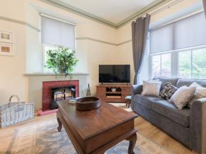 a living room with a couch and a table and a tv at Woodhaven - Uk1517 in Grange Over Sands