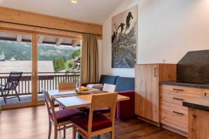 a kitchen and dining room with a table and chairs at Hohenegg Apartment Franz 2 in Campolasta