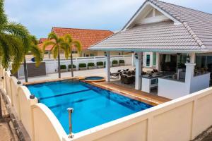 a swimming pool in the backyard of a house at Private 3 Bedroom Pool Villa PP10 in Hua Hin