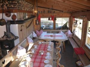 a dining room with a table and a stove at Ferienhof Almfrieden in Balderschwang