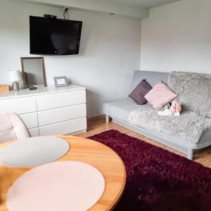 a living room with a couch and a table at Fredry 15F in Krakow