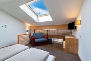 a attic bedroom with a bed and a skylight at Hohenegg Apartment Franz 2 in Campolasta