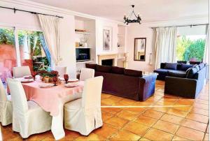 a living room with a table and a couch at Villa 9 La Alzambra-Puerto Banus in Marbella