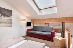 a attic bedroom with a bed and a skylight at Hohenegg Apartment Karolina in Campolasta