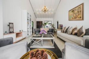 a living room with a couch and a table at The Niche by DBI in Hikkaduwa