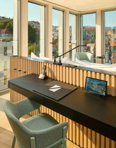 an office with a desk with a laptop and chairs at Hotel Ambasador in Split +37 photos
