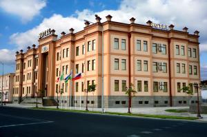 a large building on the side of a street at Hotel Diyora in Samarkand
