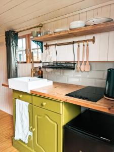 a kitchen with a sink and a counter top at Stunning Shepherd's Hut Retreat North Devon in Bideford