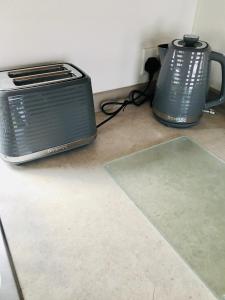 a toaster and a toaster oven sitting on the floor at Jacobs Retreat- Lido Beach- well behaved dogs welcome in Prestatyn