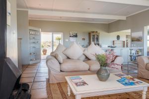 a living room with a couch and a table at Fairhill Farm in Gansbaai