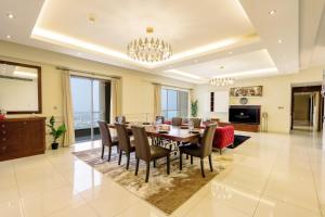 a dining room with a table and chairs at JBR The Walk Rimal - 4-Bedroom Suite Full Sea View High floor in Dubai