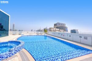 a swimming pool on the roof of a building at bnbmehomes - Live & Work 'w' Style in 1B Apt - 3007 in Dubai