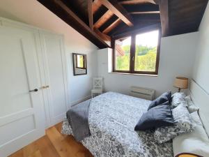 a bedroom with a bed and a window at Dreams and friends on the coast of Bilbao. in Getxo