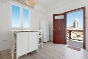 a room with a refrigerator and a door with a window at Casa Sol 21 B Garachico in Garachico