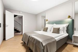 a bedroom with a large bed with a green headboard at Bob W Tallinn City Centre - Ambassador in Tallinn